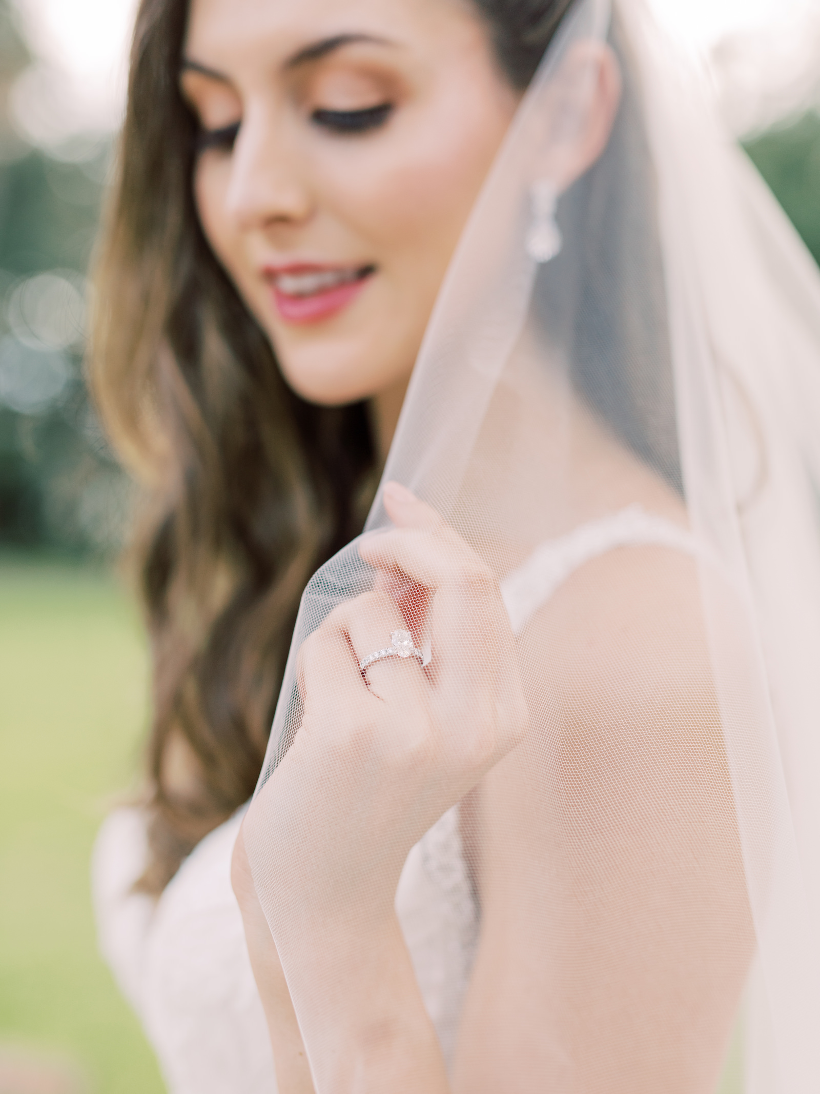 Bridal Portrait | Wedding Photo Veil Shot | Natural Bridal Makeup for the Bride | Oval Tiffany Solitaire Diamond Engagement Ring with Channel Set Diamond Band