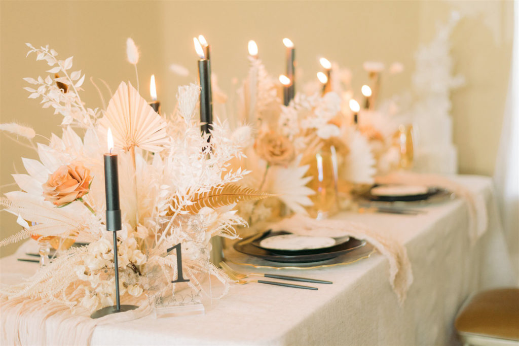 Modern Boho Wedding Reception Decor, Dried Preserved Flower Bouquets, White Feathers, Leaves and Flowers, Black Taper Candlesticks, Black Chargers, White Linens | Tampa Bay Wedding Planning, Design, Florals John Campbell Weddings | Tabletop Wedding Rentals Kate Ryan Event Rentals | Styled Shoot