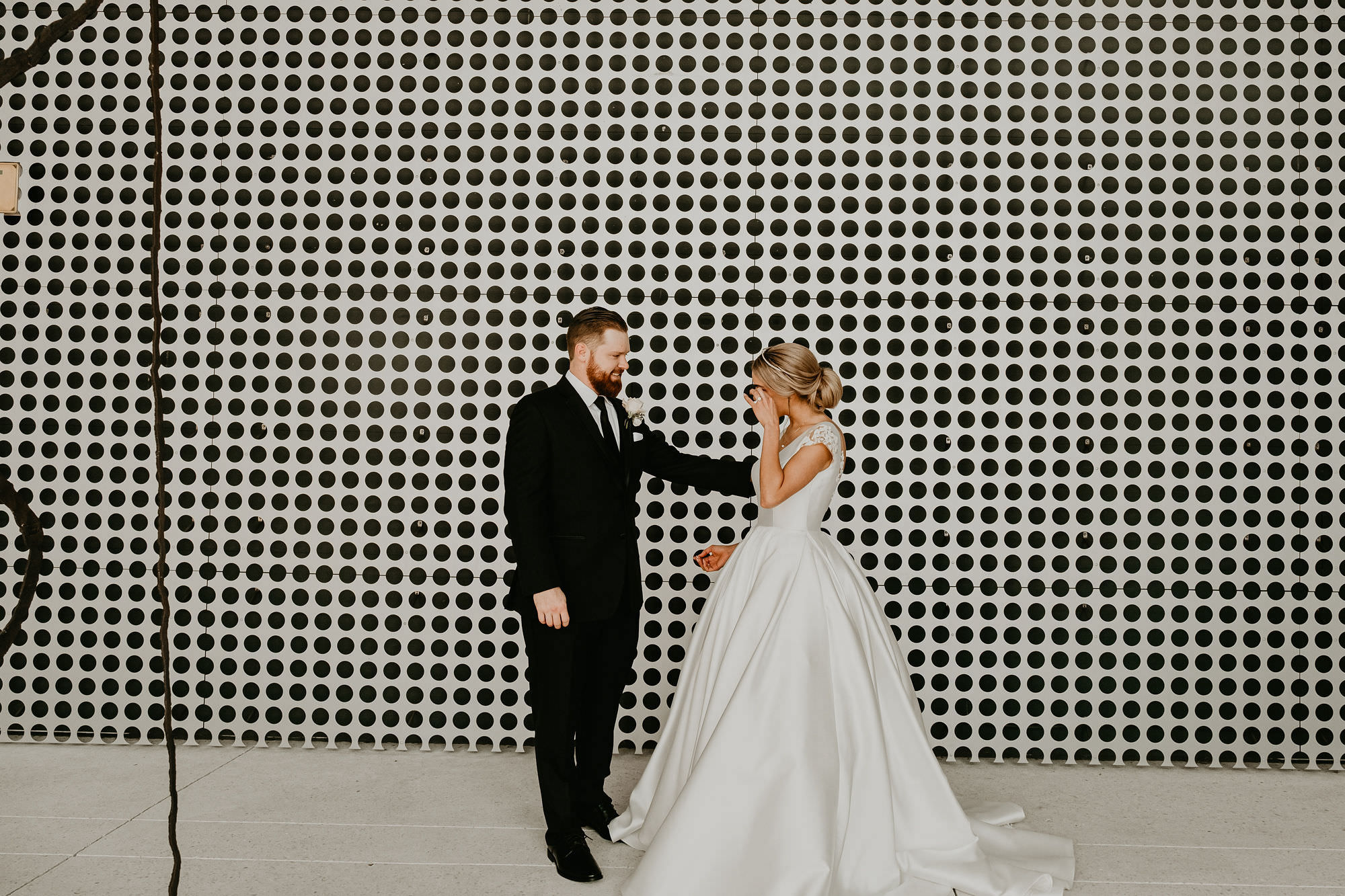 Bride and Groom First Look | Groom in Classic Black Suit Tux | Low Back Ballgown Wedding Dress by Anomalie