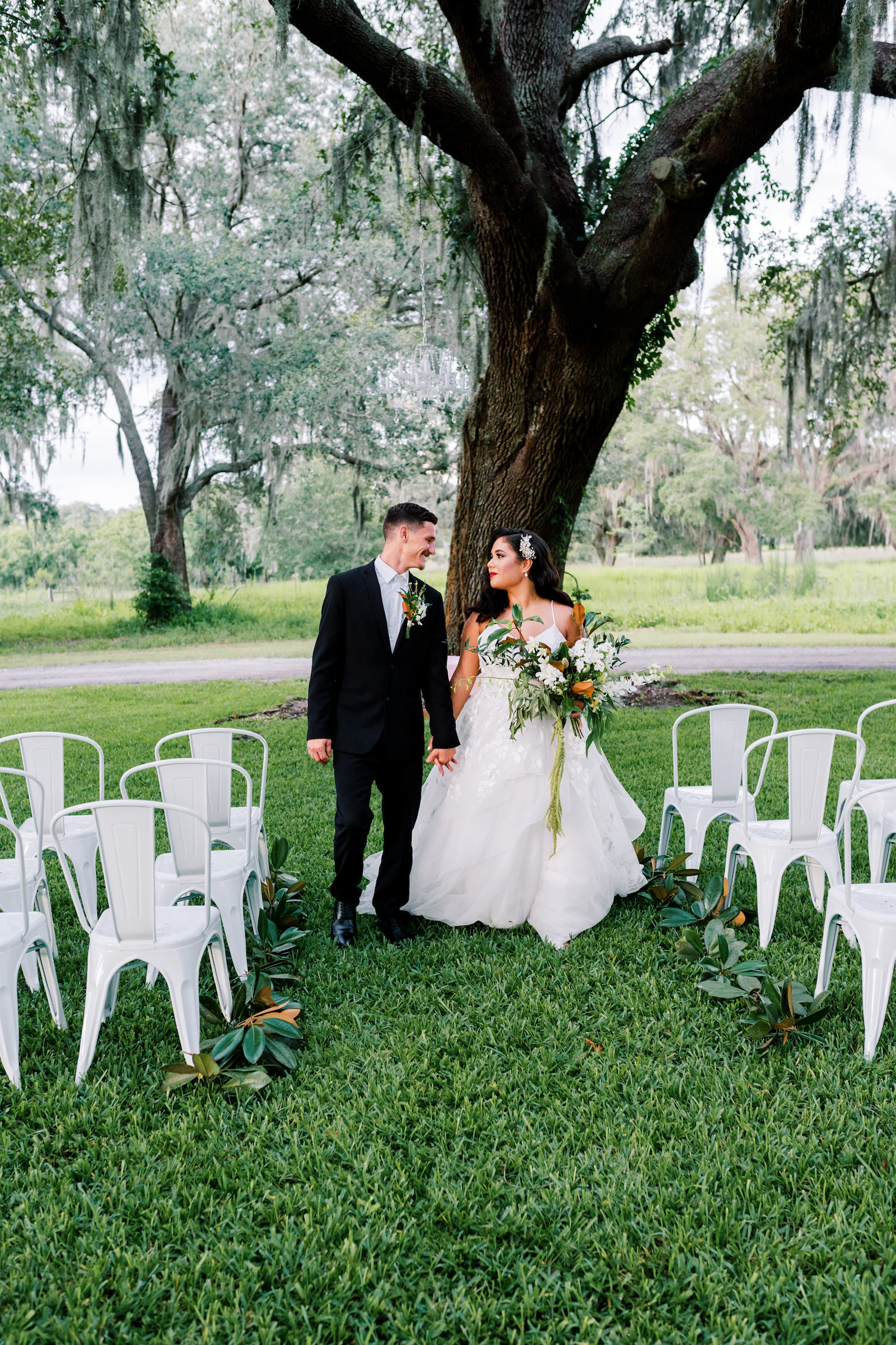 Vintage Inspired Outdoor Florida Wedding Ceremony at Two Sisters Ranch in Dade City, Bride holding Extravagant Magnolia Leaf Bouquet with White Florals, Wearing Hollywood Style Glam Hairstyle | Tampa Bay Luxury Wedding Planner EventFull Weddings