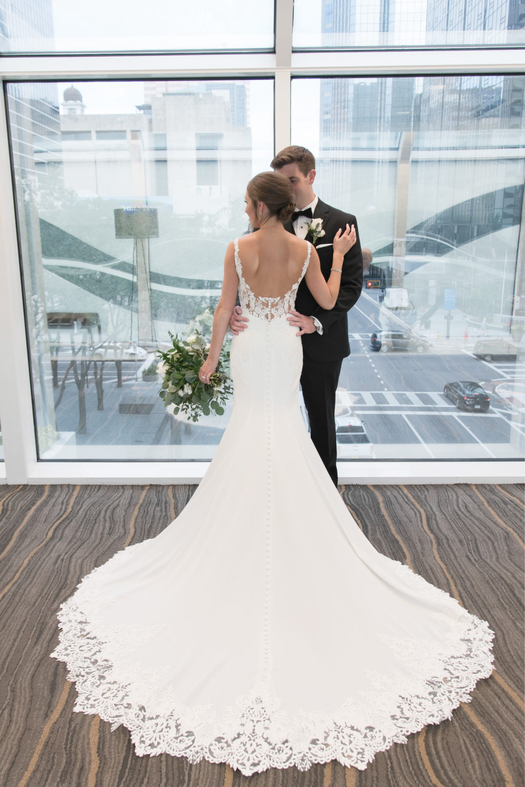 Downtown Tampa Wedding Bride and Groom Portrait at Tampa Wedding Venue The Tampa Club | Groom Wearing Classic Black Suit Tux | Stella York Designer Illusion Lace V Neck Sheath Chiffon Satin Wedding Dress Bridal Gown | Carrie Wildes Photography