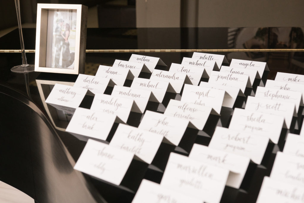 Wedding Escort Card Display with White Tent Cards and Black Calligraphy Names
