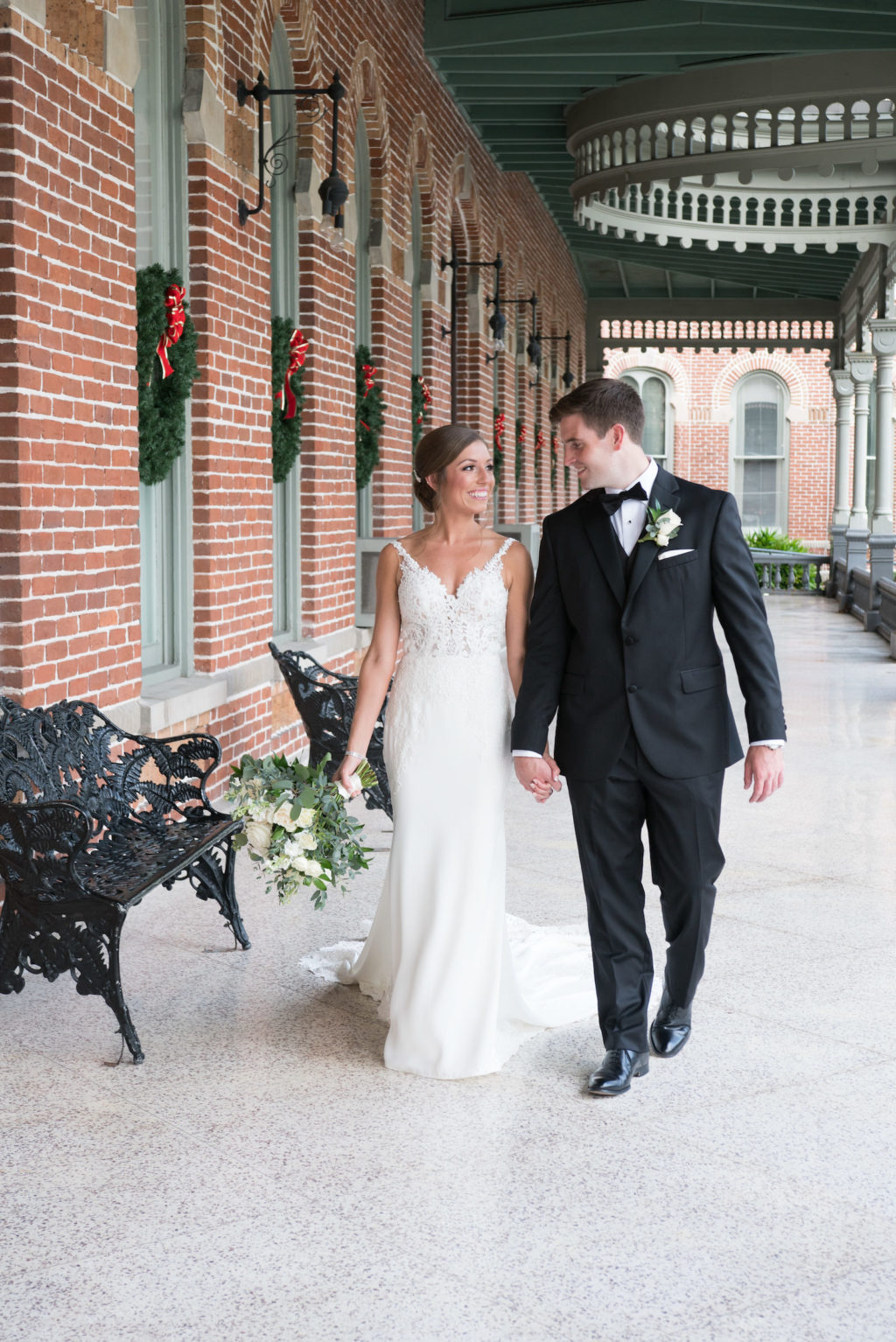Downtown Tampa Wedding Bride and Groom Outdoor Portrait at University of Tampa Plant Museum | Groom Wearing Classic Black Suit Tux | Stella York Designer Illusion Lace V Neck Sheath Chiffon Satin Wedding Dress Bridal Gown | Carrie Wildes Photography