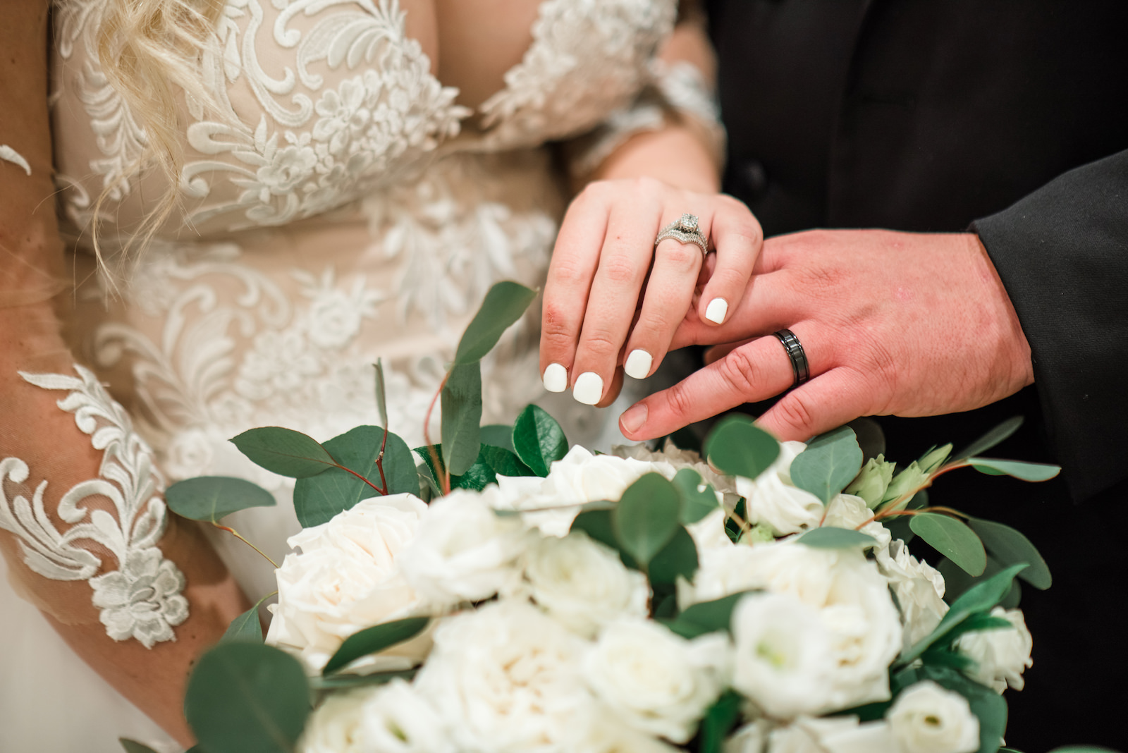 Tampa Bride and Groom Showing Off Hands with Wedding Rings, Neutral White Roses and Eucalyptus Floral Bouquet | Tampa Wedding Florist Iza's Flowers