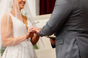 Bride and Groom Exchanging Rings during Traditional Tampa Church Wedding Ceremony