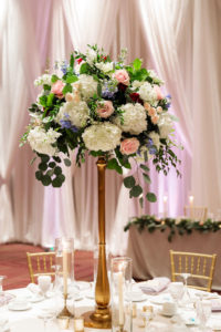 Tampa Wedding Tall Gold Centerpieces of White Hydrangea, Blush Pink and Deep Red Roses and Dusty Blue Eucalyptus Greenery by Tampa Wedding Florist Monarch Events and Design