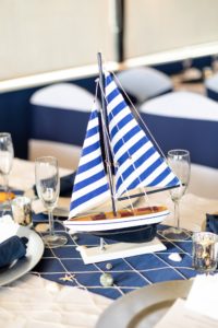 Nautical Inspired Wedding Reception Decor with Wooden Boat Centerpieces