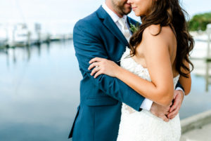 Bride and Groom Outdoor Portrait along Marina Dock at Tampa wedding venue westshore Yacht Club | Lace Strapless Sweetheart Scalloped Edge Train Wedding Dress Bridal Gown | Groom Wearing Classic Navy Suit | Dewitt for Love Photography