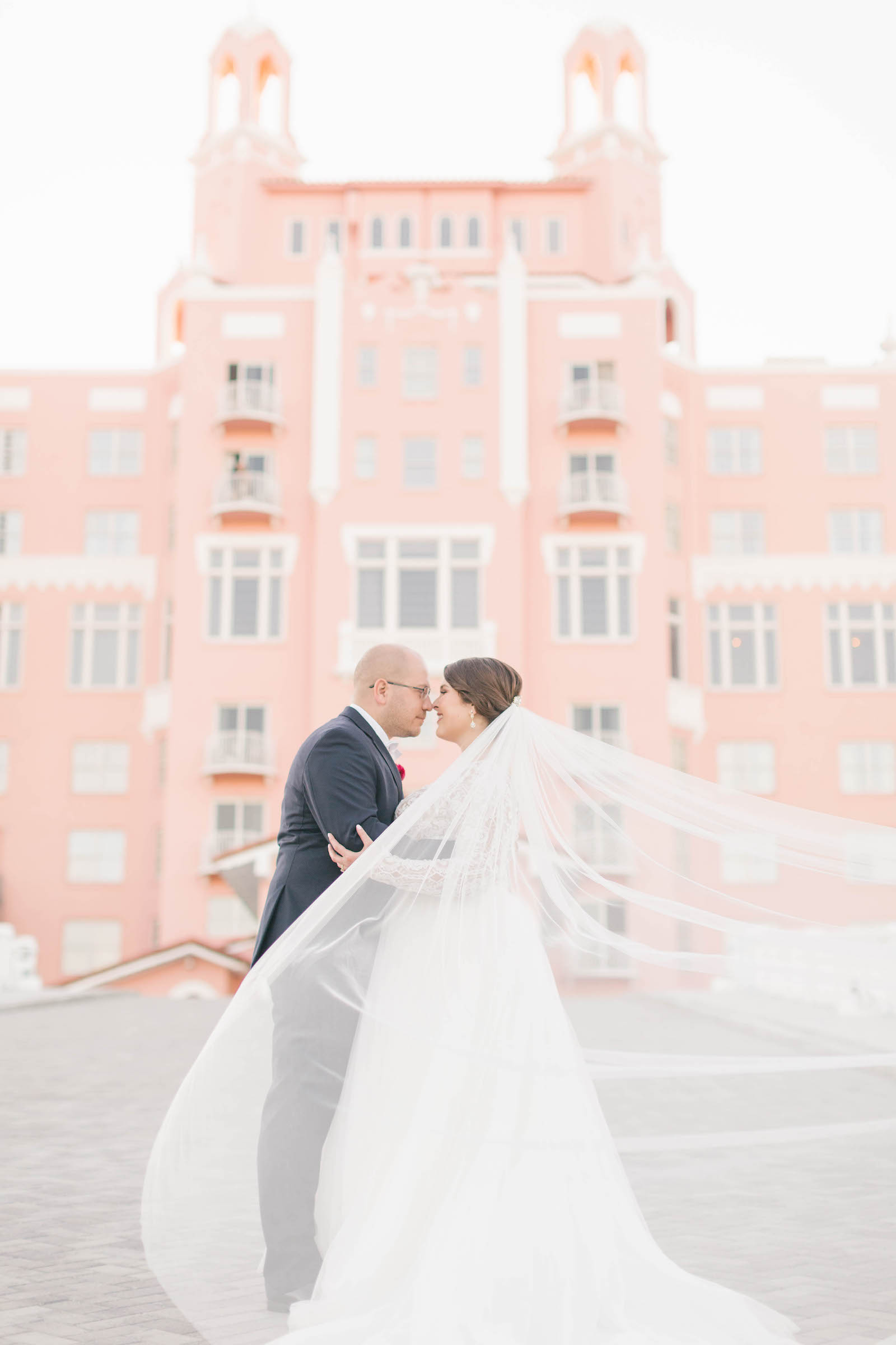 Florida Bride and Groom Veil Wedding Photo in Front of The Pink Palace | Historic St. Pete Waterfront Wedding Venue The Don Cesar