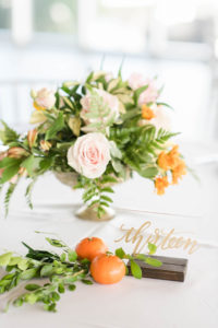 Tropical Wedding Reception Decor, Low Floral Centerpiece, Blush Pink and Orange Flowers, Greenery, Tangerine Fruits and Acrylic with Gold Script Table Number | Tampa Bay Wedding Planner Coastal Coordinating