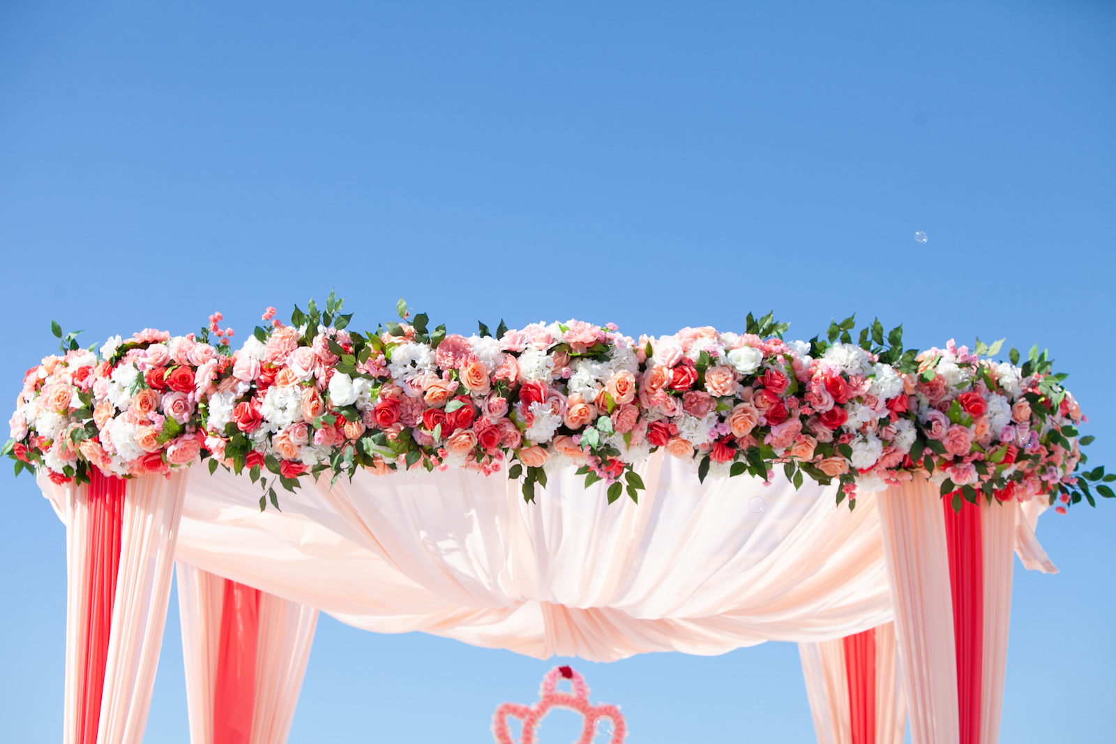 Tampa Clearwater Beach Indian Wedding Mandap with Pink and Coral Draping and Pink Peach Coral Roses