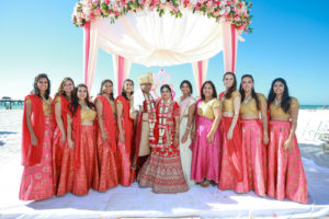 Tampa Clearwater Beach Indian Wedding Party with Coral Pink Sari and Mandap with Pink and Coral Draping and Pink Peach Coral Roses