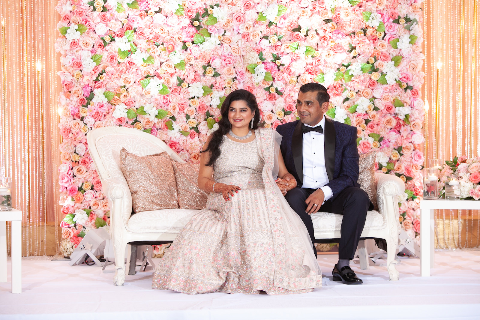 Bride and Groom Indoor Portrait at Tampa Clearwater Beach Indian Wedding Stage with Floral Wall and Twinkle Light Curtain Wall