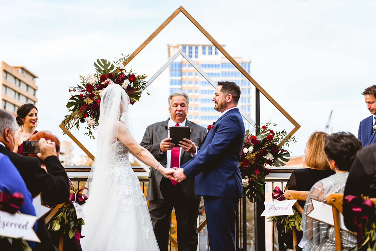 Bride and Groom Exchanging Wedding Vows During Rooftop Ceremony in Front of Geometric Sculpture | Tampa Bay Wedding Planner Special Moments Event Planning | Downtown St. Pete Wedding Venue Red Mesa Events