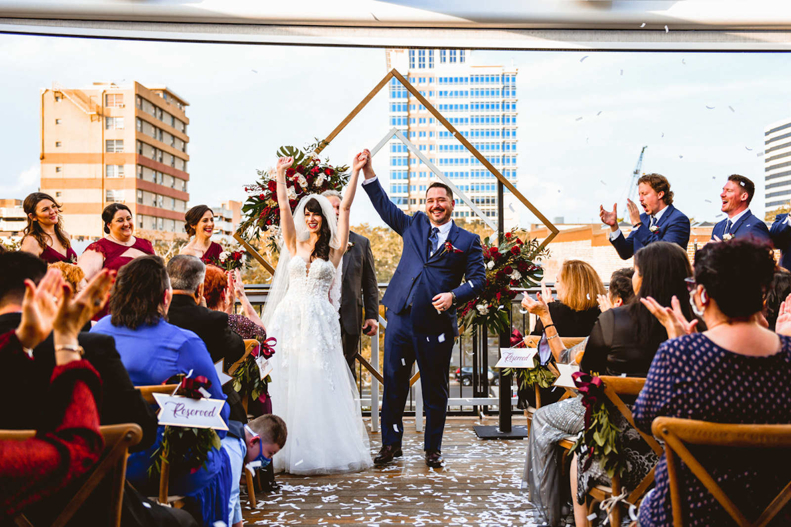 Bride and Groom After Saying I Do During Rooftop Ceremony in Front of Geometric Sculpture Confetti Photo | Tampa Bay Wedding Planner Special Moments Event Planning | Downtown St. Pete Wedding Venue Red Mesa Events