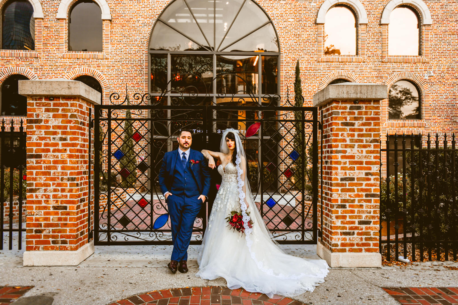 Florida Bride in Essense of Australia A-Line Wedding Dress and Groom in Blue Suit Outside Downtown St. Pete Wedding Venue Red Mesa Events