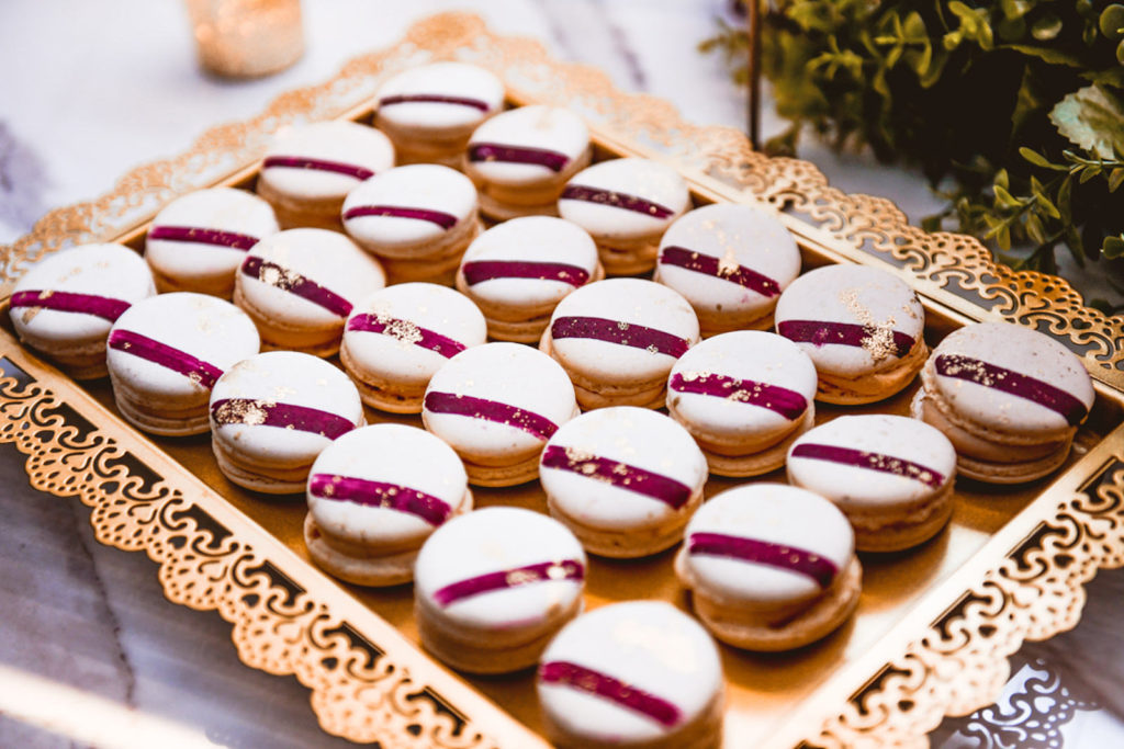 Wedding Reception Desserts, White, Burgundy Striped and Gold Flakes Macaroons on Gold Platter