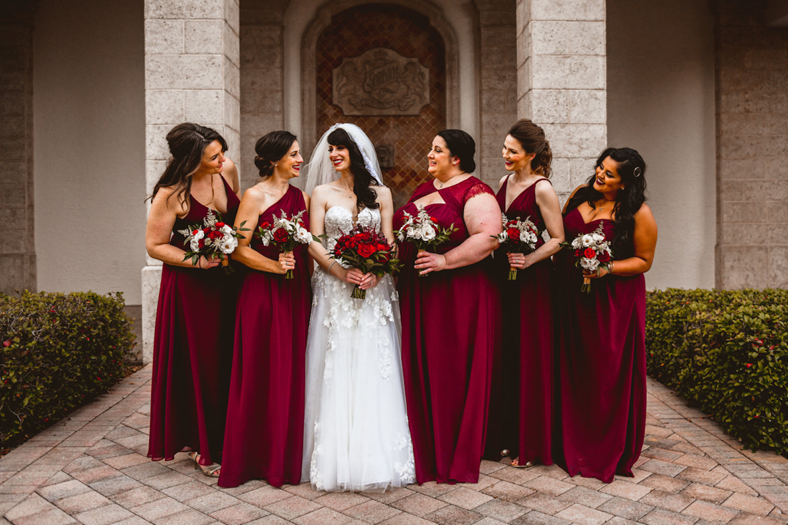 Florida Bride in Essense of Australia Strapless, Floral Applique and Tulle Skirt A-Line Wedding Dress Getting Ready with Bridesmaids in Burgundy Red Mix and Match Dresses Holding Red Floral Bouquets