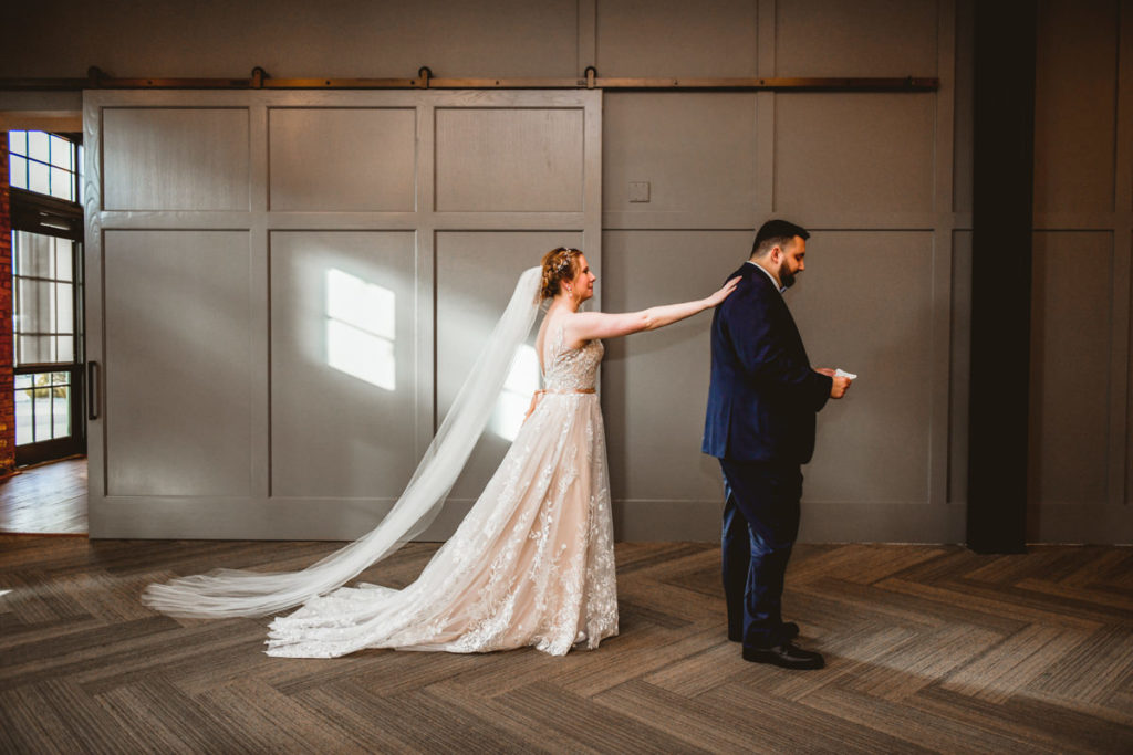 Bride in Lace and Tulle Boho Wedding Dress First Look with Groom | Tampa Industrial Wedding Venue Armature Works
