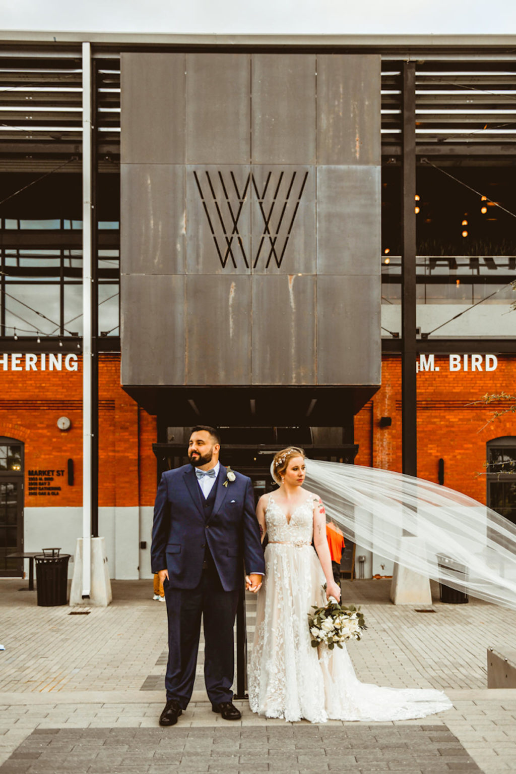 Bride and Groom Holding Hands Portrait Outside Tampa Industrial Wedding Venue Armature Works