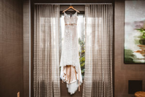 Romantic Lace Wedding Dress Hanging on Window with Nude Lining and Belt
