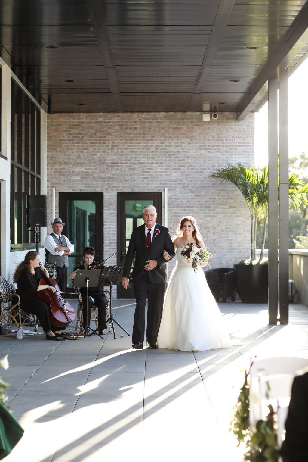Bride and Father Walking Down Aisle at Outdoor Terrace Wedding Ceremony at Tampa Wedding Venue Hyde House