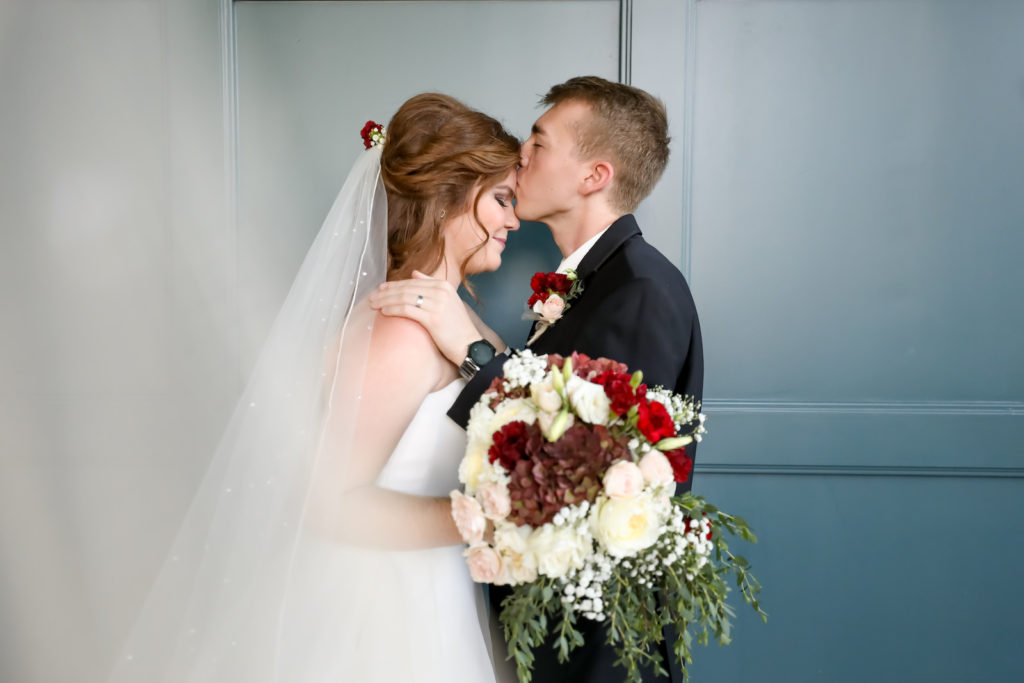 Bride and Groom Portrait | Groom Wearing Classic Black Suit Tux | Long Pearl Studded Cathedral Veil | Bridal Wedding Bouquet with Burgundy and White Hydrangea, Red Carnations, White Roses, Baby's Breath and Greenery | Lifelong Photography Studio