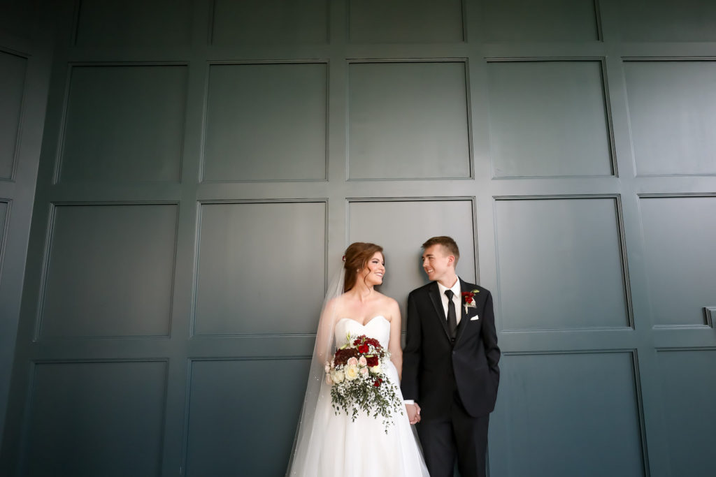 Bride and Groom Portrait | Groom Wearing Classic Black Suit Tux | Bride Wearing Organza Sweetheart Neckline Sincerity Bridal Gown Wedding Dress with Long Pearl Studded Cathedral Veil | Bridal Wedding Bouquet with Burgundy and White Hydrangea, Red Carnations, White Roses, Baby's Breath and Greenery | Lifelong Photography Studio