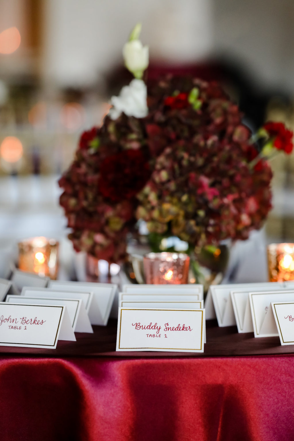 Tampa Wedding Escort Card Table with Burgundy Red Table Linen and Maroon Hydrangea Centerpiece