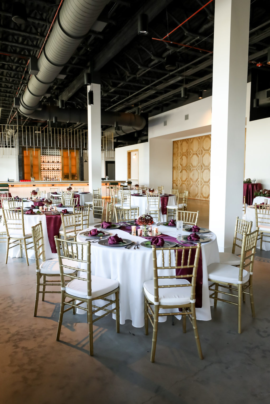 Tampa Wedding Reception at South Tampa Wedding Venue Hyde House | Round Reception Tables with White Linens and Burgundy Runners and Napkins with Gold Charger Plates and Gold Chiavari Chairs by A Chair Affair