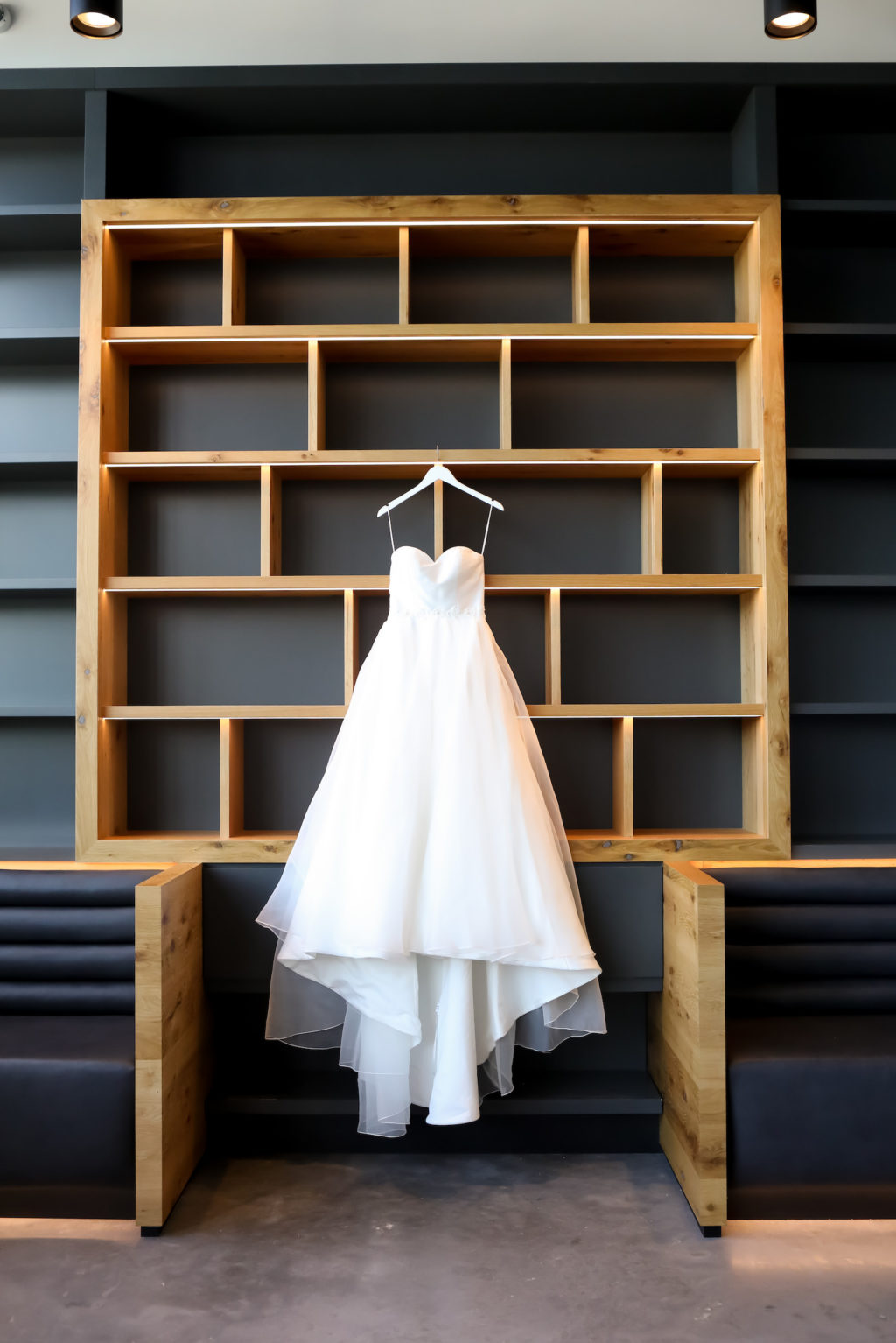 Wedding Dress Hanger Shot on Modern Bookshelf Wall at Tampa Wedding Venue Hyde House | Sincerity Bridal Designer Wedding Dress Bridal Gown with Sweetheart Neckline