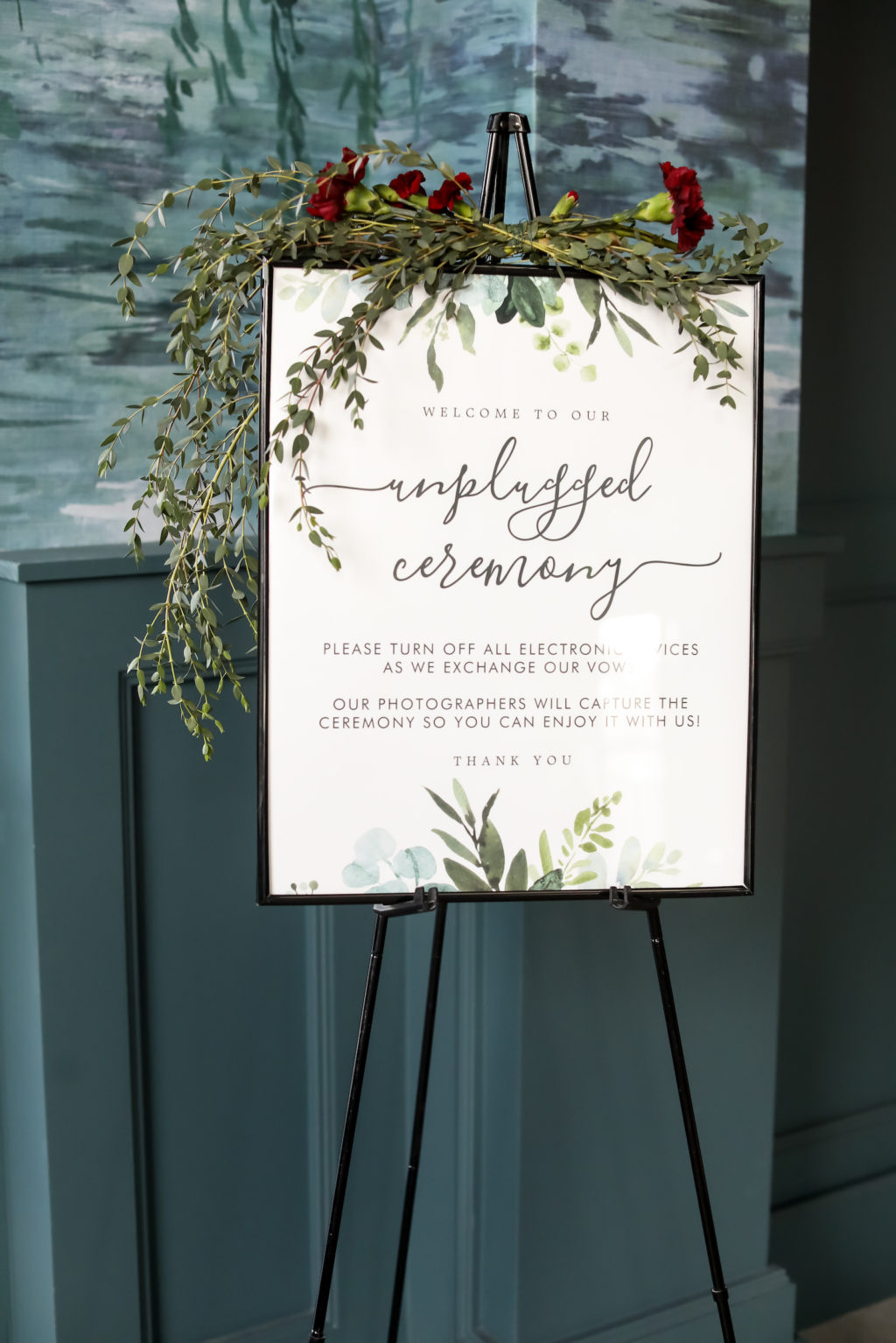Unplugged Wedding Ceremony Sign on Easel with Greenery Garland and Burgundy Carnations