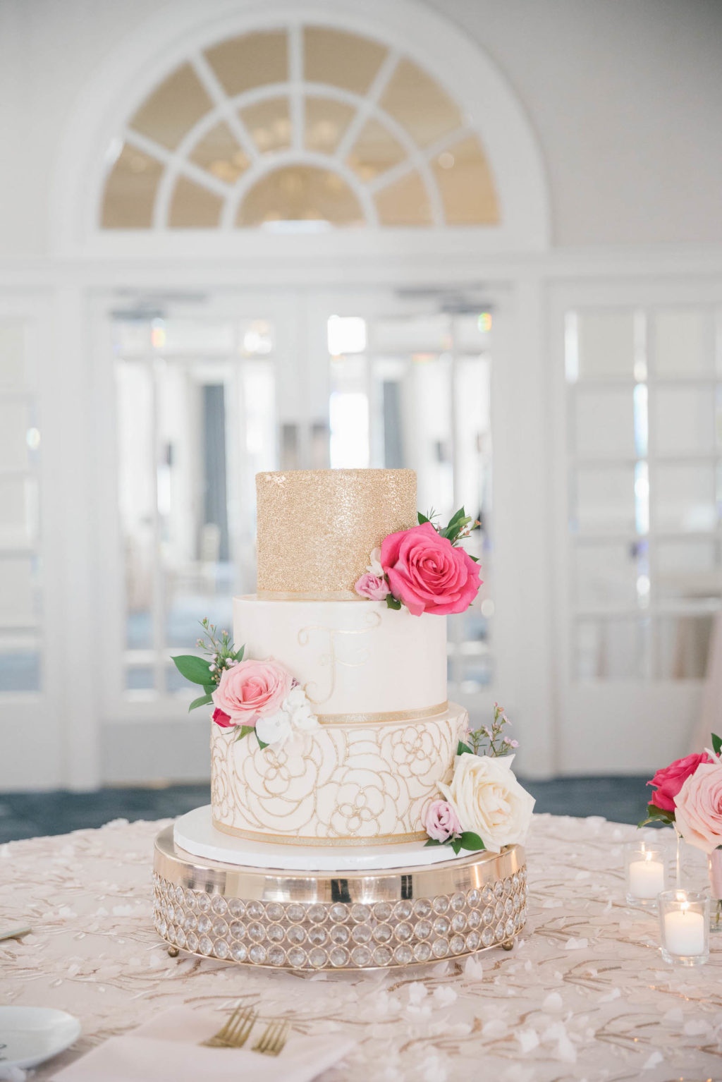 Three Tier White and Gold Wedding Cake with Vibrant Pink Roses on Crystal and Gold Cake Stand | Tampa Bay Wedding Planner Parties A'la Carte | Wedding Cake The Artistic Whisk