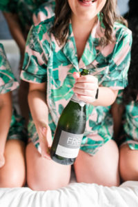 Tampa Bride in Tropical Pajamas Popping Bottle of Champagne