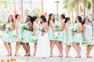 Tropical Bride and Bridesmaids in Matching Pink and Seafoam Green Short Dresses Holding White Floral Bouquets | Tampa Bay Wedding Hair and Makeup Adore Bridal | Blogger Girl Meets Bow