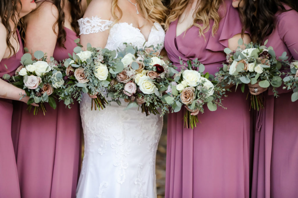 Classic Bride in Lace Off the Shoulder Dress Holding Ivory, Mauve and Dark Burgundy Red Roses with Greenery and Eucalyptus Floral Bouquets | Bridesmaids in Dusty Rose Dresses | Tampa Bay Wedding Photographer Lifelong Photography Studio | Wedding Florist Monarch Events and Deisgn