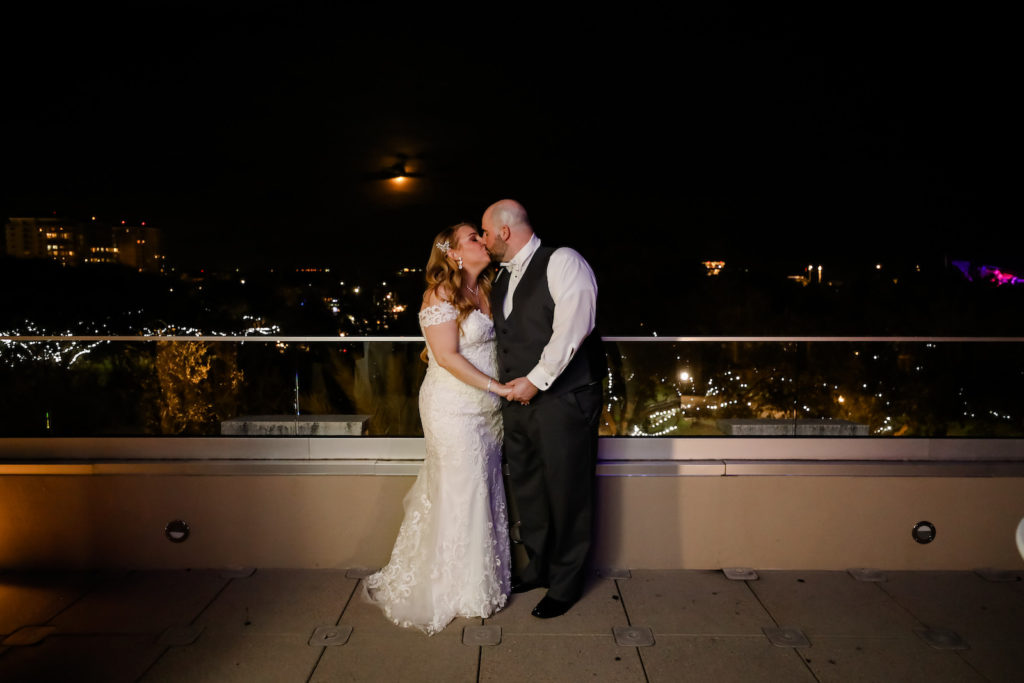 Florida Bride and Groom Kissing on Rooftop at Night | Downtown St. Pete Boutique Wedding Venue The Birchwood | Tampa Wedding Photographer Lifelong Photography Studio