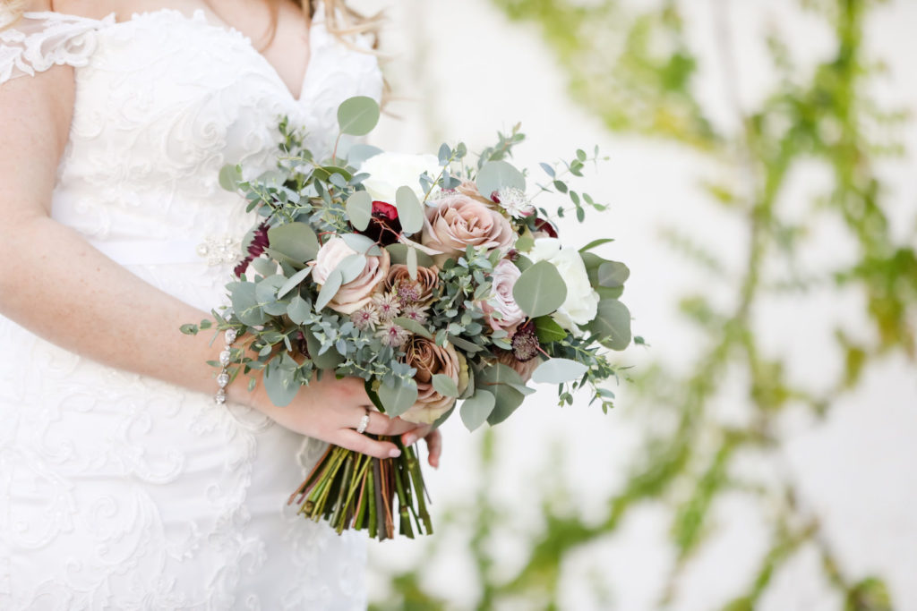 Florida Bride Holding Jewel Tone Floral Bouquety, Mauve and Burgundy Red Roses with Greenery and Eucalyptus | Tampa Bay Wedding Florist Monarch Events and Design | Wedding Photographer Lifelong Photography Studio