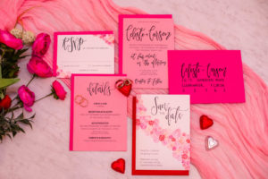 Valentine Inspired Pink and Red Stationery Wedding Invite Flat Lay