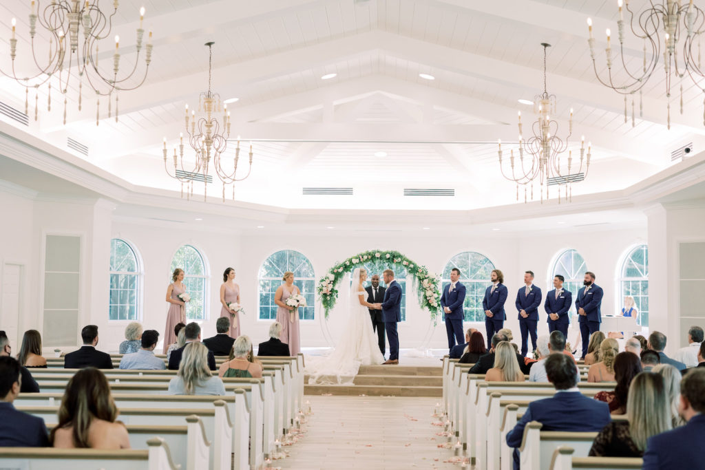 Florida Bride and Groom Exchanging Wedding Vows During Timeless Romantic Wedding Ceremony, Round Arch with Greenery and Blush Pink, Ivory Flowers | Tampa Bay Wedding Planner Special Moments Event Planning | Safety Harbor Traditional Wedding Venue Harborside Chapel