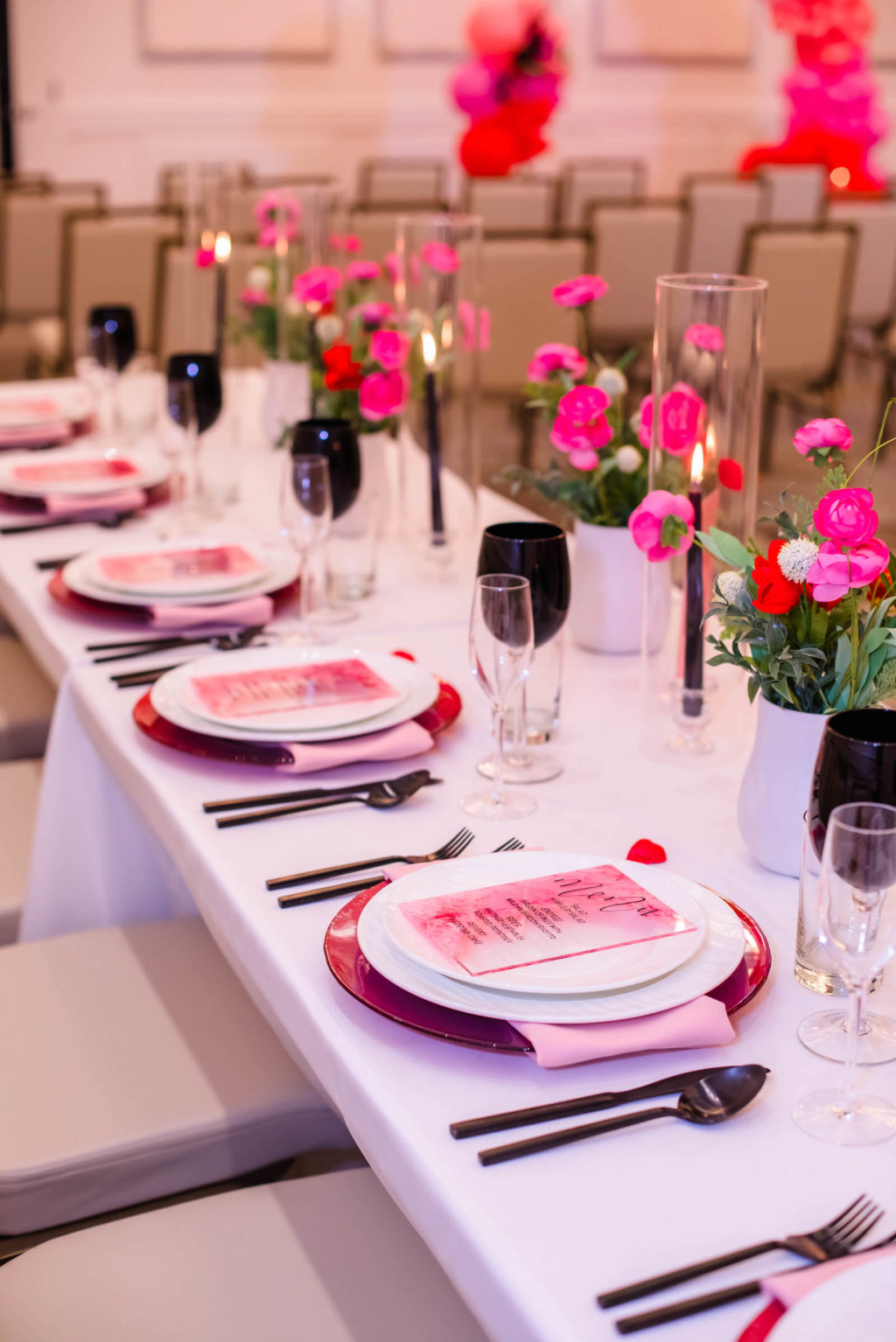 Valentine Inspired Reception Feasting Table with Hurricane Glass Centerpieces with Pink and Red Florals by A Chair Affair | EventFull Weddings