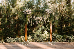 Outdoor Wedding Ceremony Backdrop wood Arch Arbor with Greenery and White Roses and Suspended Hanging Stock Flowers