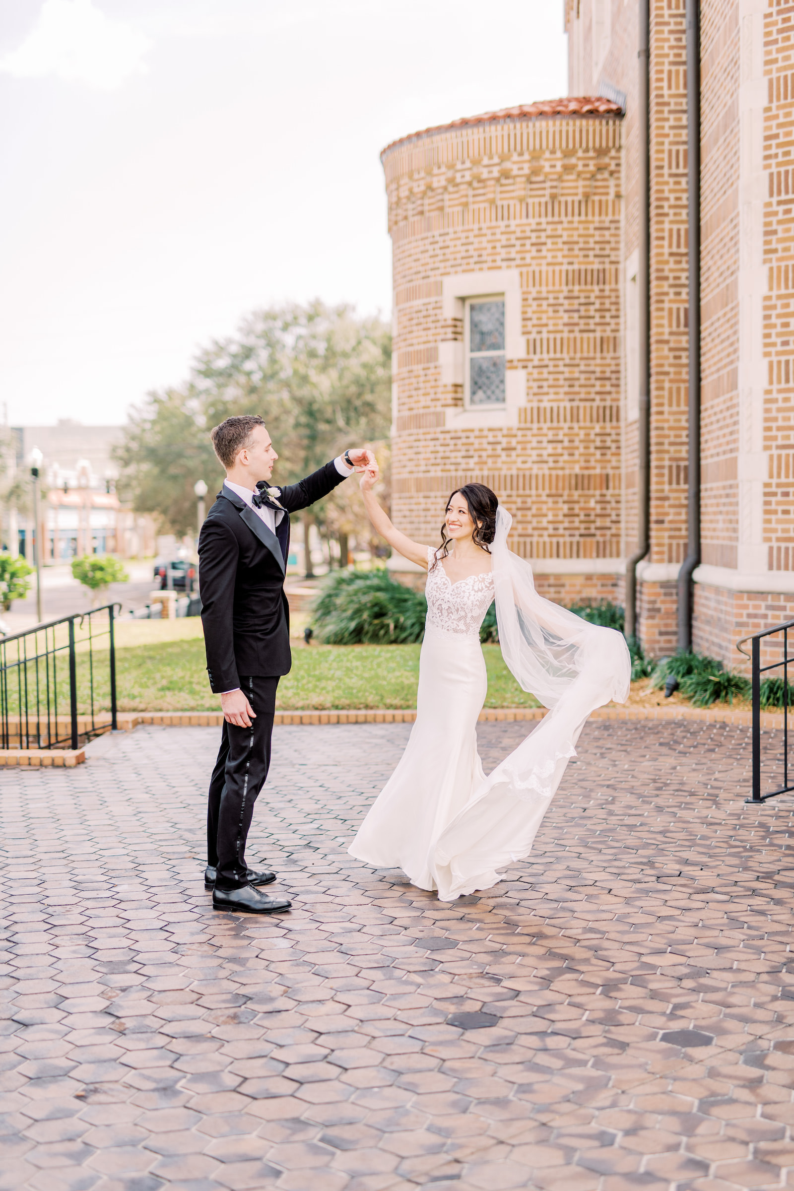 Florida Groom Spinning Bride Outside St. Pete Wedding Ceremony Venue St. Mary Our Lady of Grace Catholic Church | Tampa Bay Wedding Photographer Kera Photography