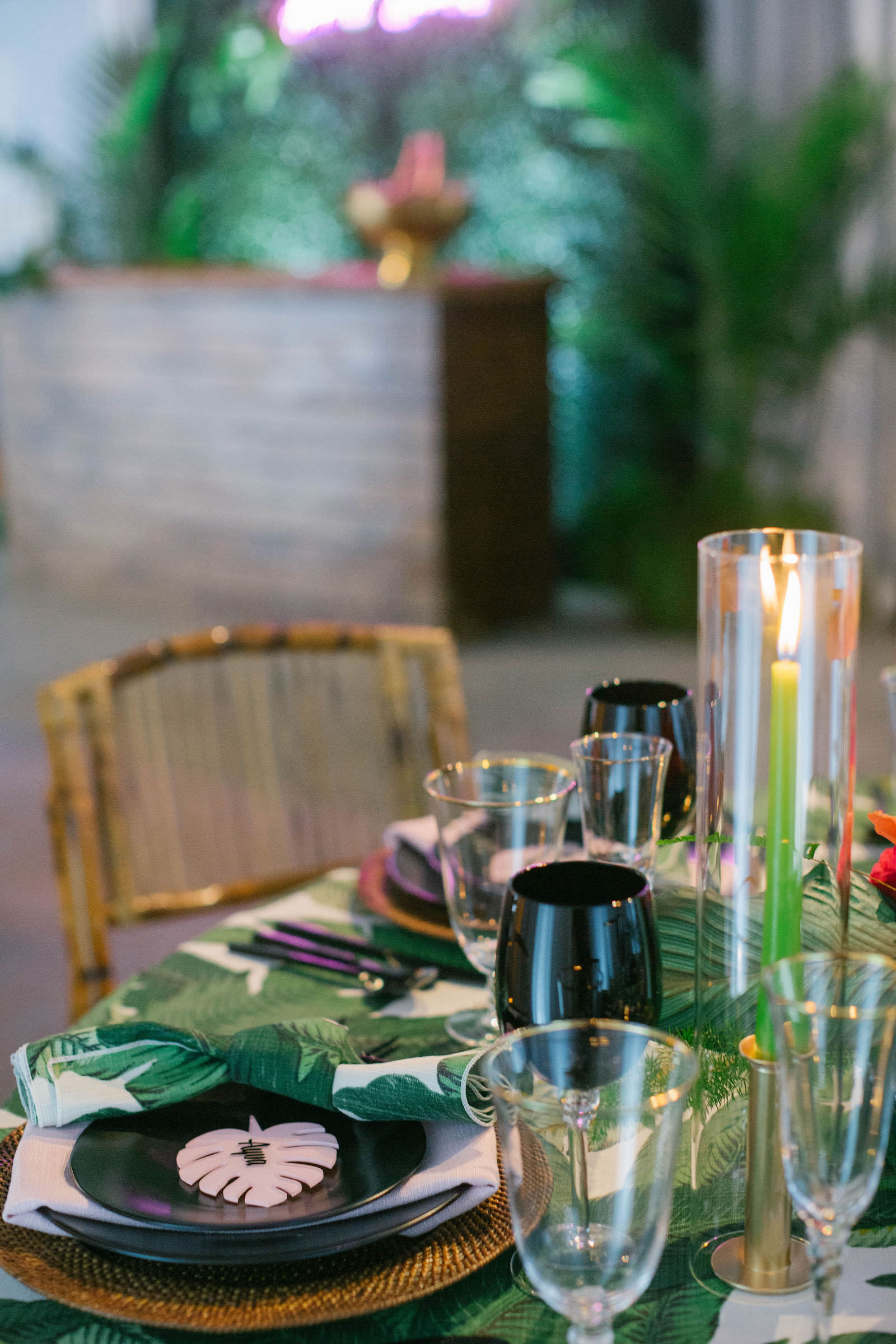 Palm Leave Linen with Wicker Charger, Black Place Setting, Palm Leaf Name Card, and Dishes, and Candle Centerpieces | Tropical Destination Beach Wedding Inspiration | Bellwether Beach Resort Styled with Love by Marry Me Tampa Bay