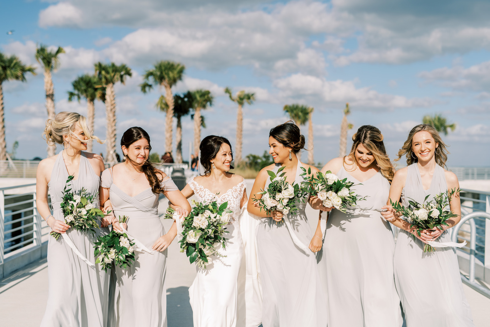 Bride in Wtoo by Watters Lace and Illusion Crepe Off the Shoulder Wedding Dress, Bridesmaids in Mix and Match Gray Dresses | Tampa Bay Wedding Photographer Kera Photography | Wedding Hair and Makeup Femme Akoi | St. Pete Pier Bridal Party Portrait