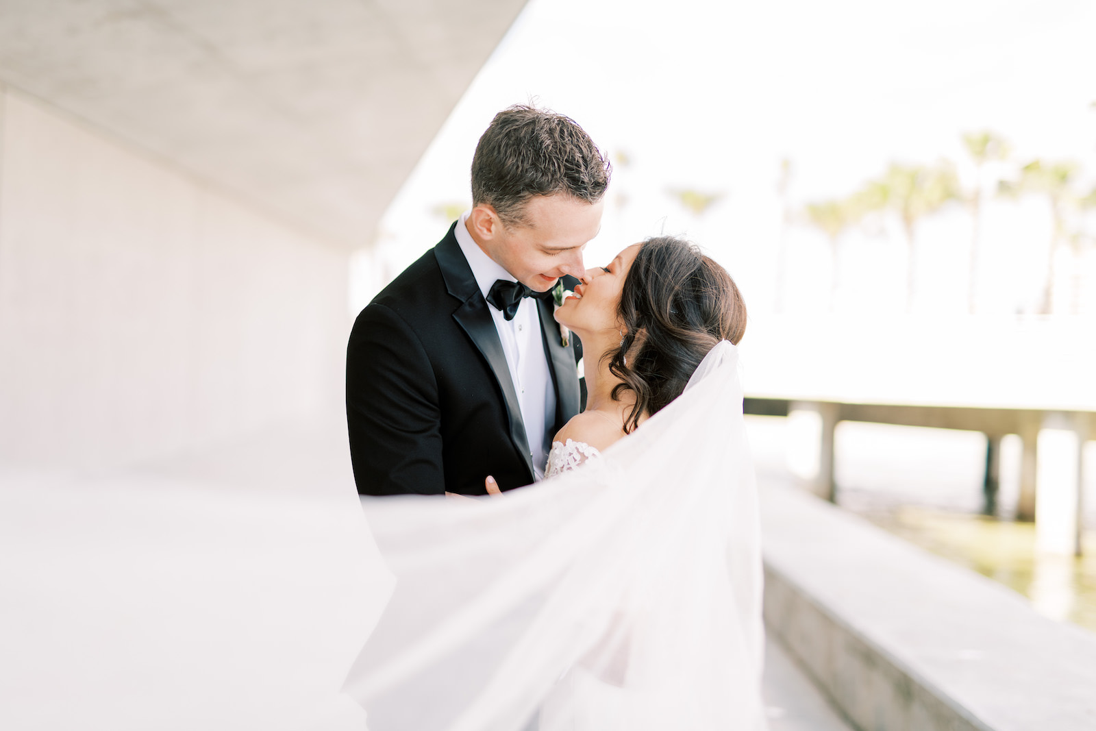Florida Bride and Groom Intimate Kiss with Veil Blowing in Wind | Tampa Bay Wedding Photographer Kera Photography | Wedding Hair and Makeup Femme Akoi