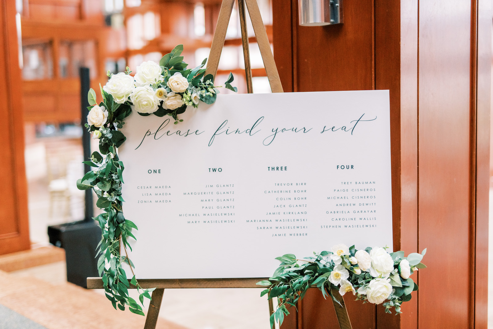 Minimal Wedding Reception Decor, White Seating Chart Sign on Wooden Easel with Eucalyptus Greenery and White Roses Garland | Tampa Bay Wedding Photographer Kera Photography