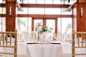 Modern Minimal Wedding Reception Decor, White Table with Gold Chiavari Chairs, Low Greenery and White Roses Floral Centerpiece | Tampa Bay Wedding Photographer Kera Photography | St. Pete Wedding Venue Poynter Institute | Amici's Catered Cuisine