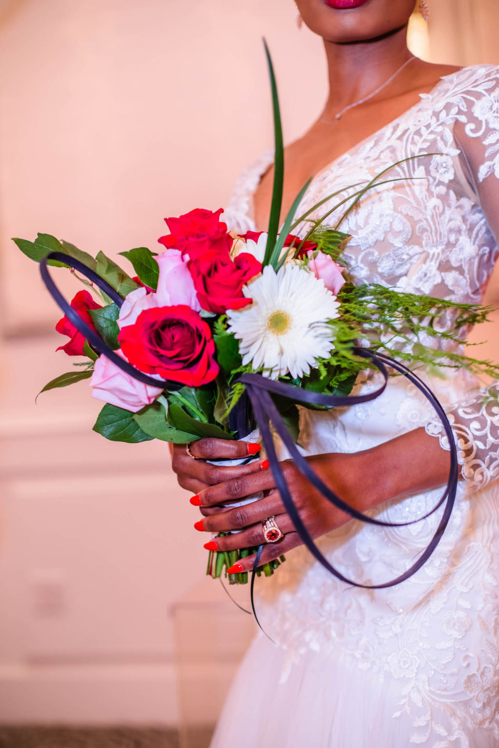 Bride Holding Simple Red, Pink, and White Bridal Bouquet with Lace Long Sleeve Wedding Gown Portrait