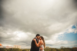 Tampa Bride and Groom Kissing on Rooftop Balcony of St. Pete Wedding Venue The Birchwood